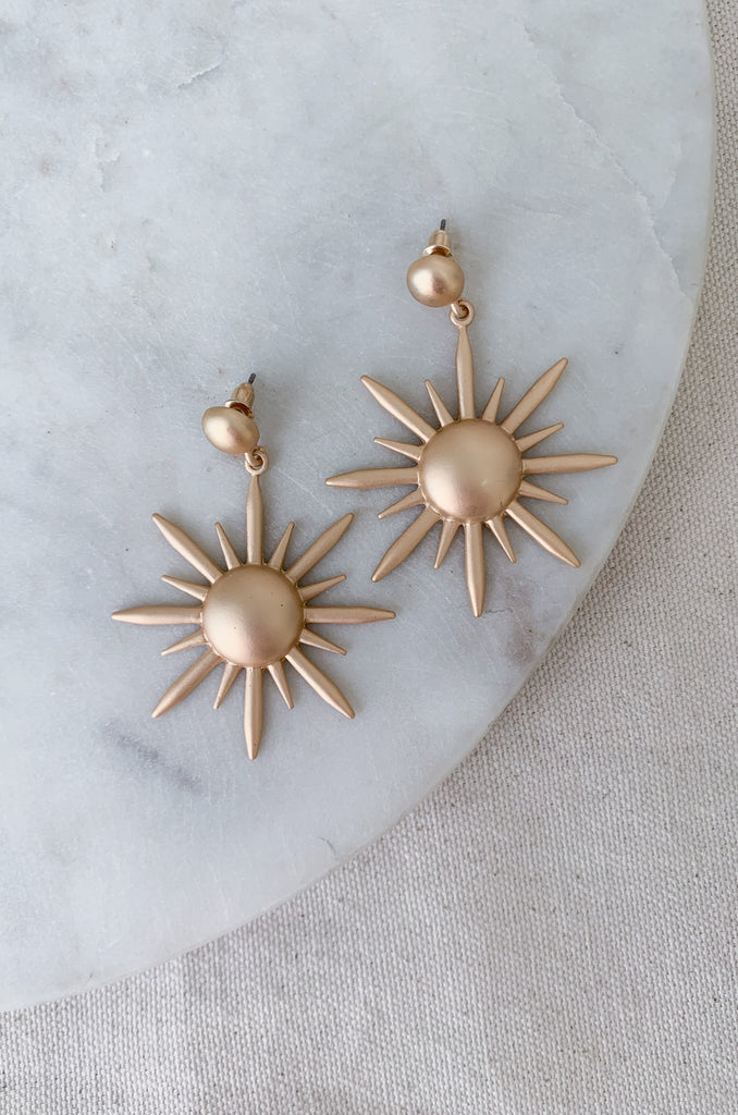 The Matte Gold Large Starburst Earrings are so fun! They have a brushed matte look, which stands out. These are definitely a statement earring with a large dangle starburst. These are lightweight and comfortable, despite the large design. You could easily dress up any look with these gold earrings. 