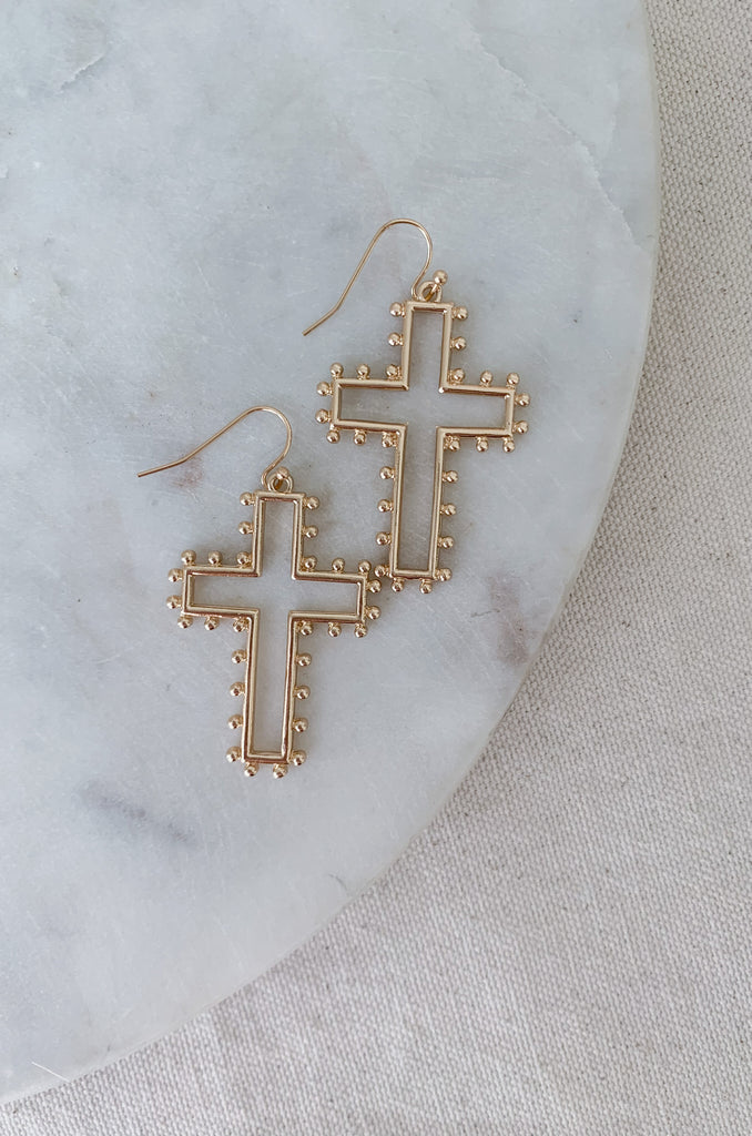 The Medium Open Cross Dangle Earrings are a special statement jewelry! We love the large cross and dot design. These earrings are also lightweight and comfortable. Choose between gold or silver to complete your look. 