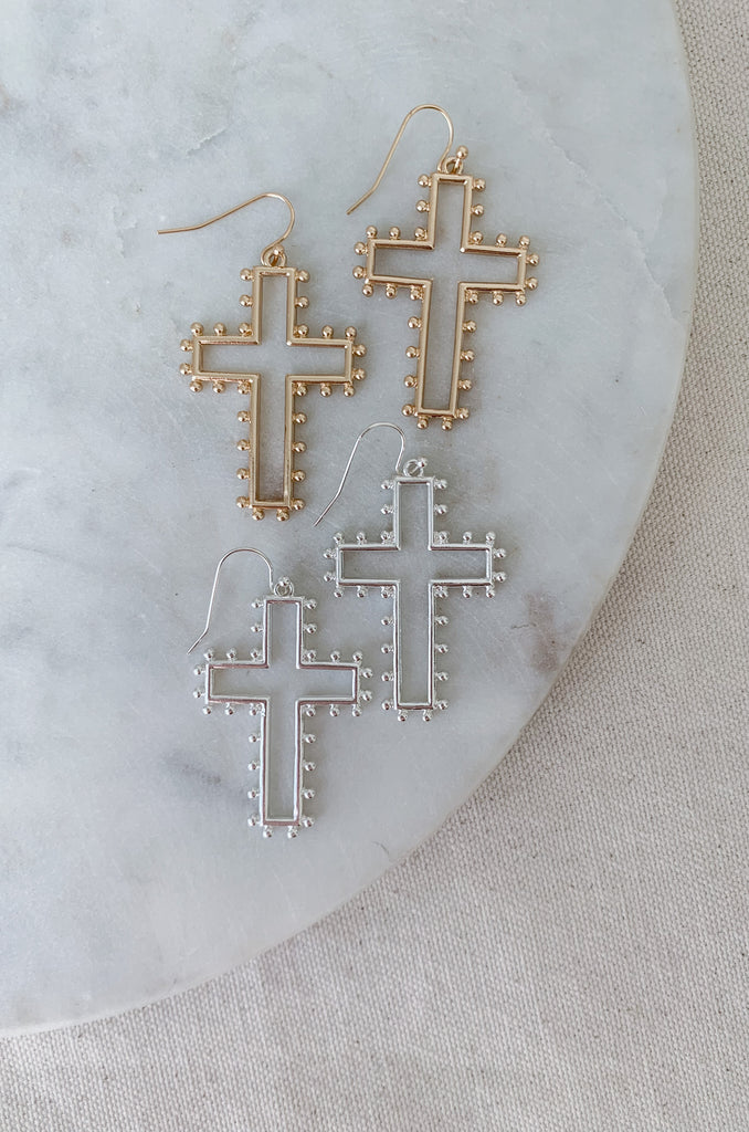 The Medium Open Cross Dangle Earrings are a special statement jewelry! We love the large cross and dot design. These earrings are also lightweight and comfortable. Choose between gold or silver to complete your look. 