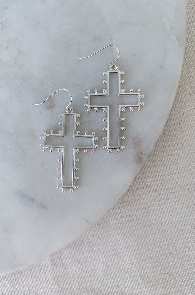 The Medium Open Cross Dangle Earrings are a special statement jewelry! We love the large cross and dot design. These earrings are also lightweight and comfortable. Choose between gold or silver to complete your look. 