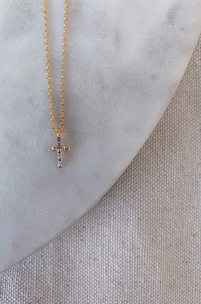 The Mini Cross Gold Necklace is the perfect gift for someone else, or for yourself! This style has a 1/2" Cross pendant that is filled with gorgeous gems that catch the light in a beautiful way. It's an everyday staple.