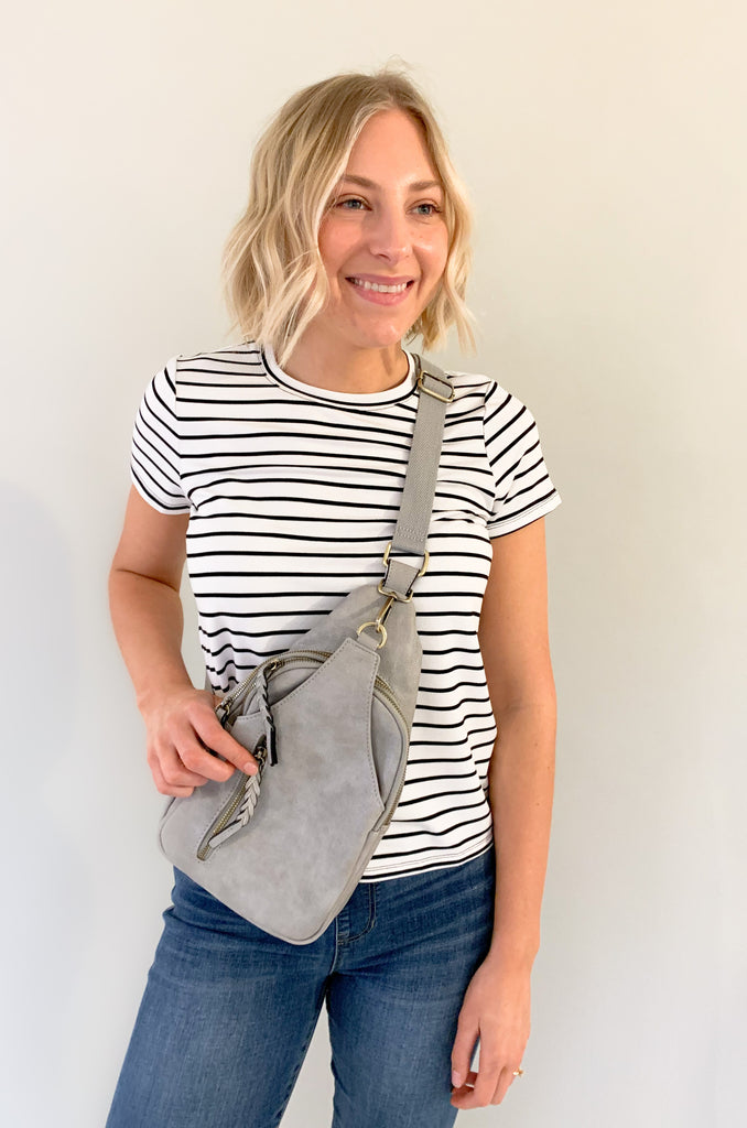 The Nikki Sling Handbags are perfect for on-the-go! They are a hands free, not fuss style that will fit all of the essentials. This bag is made from the softest vegan leather and has a tonal fabric strap (these straps are not detachable). It also has several large pockets. Choose between black, grey, and ivory to complete your look!