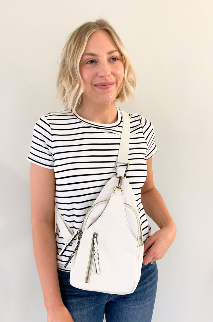 The Nikki Sling Handbags are perfect for on-the-go! They are a hands free, not fuss style that will fit all of the essentials. This bag is made from the softest vegan leather and has a tonal fabric strap (these straps are not detachable). It also has several large pockets. Choose between black, grey, and ivory to complete your look!