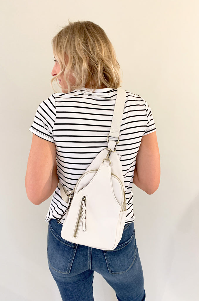 The Nikki Sling Handbags are perfect for on-the-go! They are a hands free, not fuss style that will fit all of the essentials. This bag is made from the softest vegan leather and has a tonal fabric strap (these straps are not detachable). It also has several large pockets. Choose between black, grey, and ivory to complete your look!