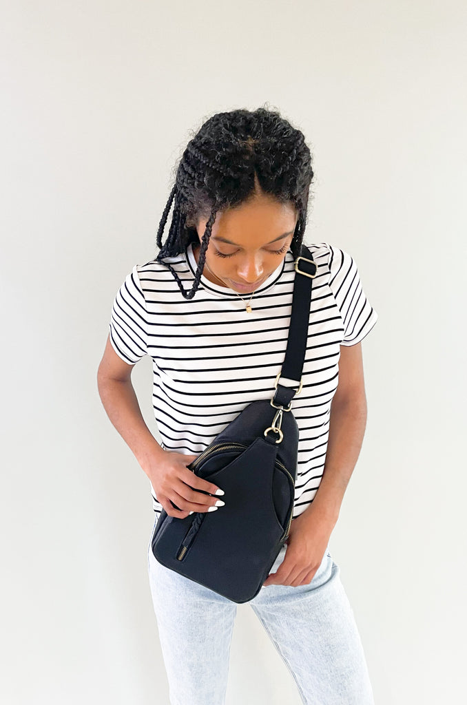 The Nikki Sling Handbags are perfect for on-the-go! They are a hands free, not fuss style that will fit all of the essentials. This bag is made from the softest vegan leather and has a tonal fabric strap (these straps are not detachable). It also has several large pockets. Choose between black, grey, and ivory to complete your look!