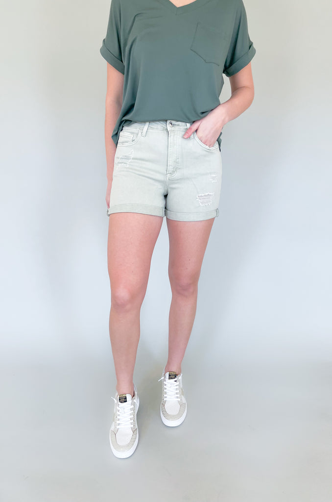 The Rebecca High Rise Distressed Shorts have a fresh look for spring and summer. Colored bottoms create an elevated outfit, plus they are just fun! This style is a washed, olive green with distressing on the front and back. The bottom hem can be unrolled to create a longer short. The fabric is soft and stretchy too! 