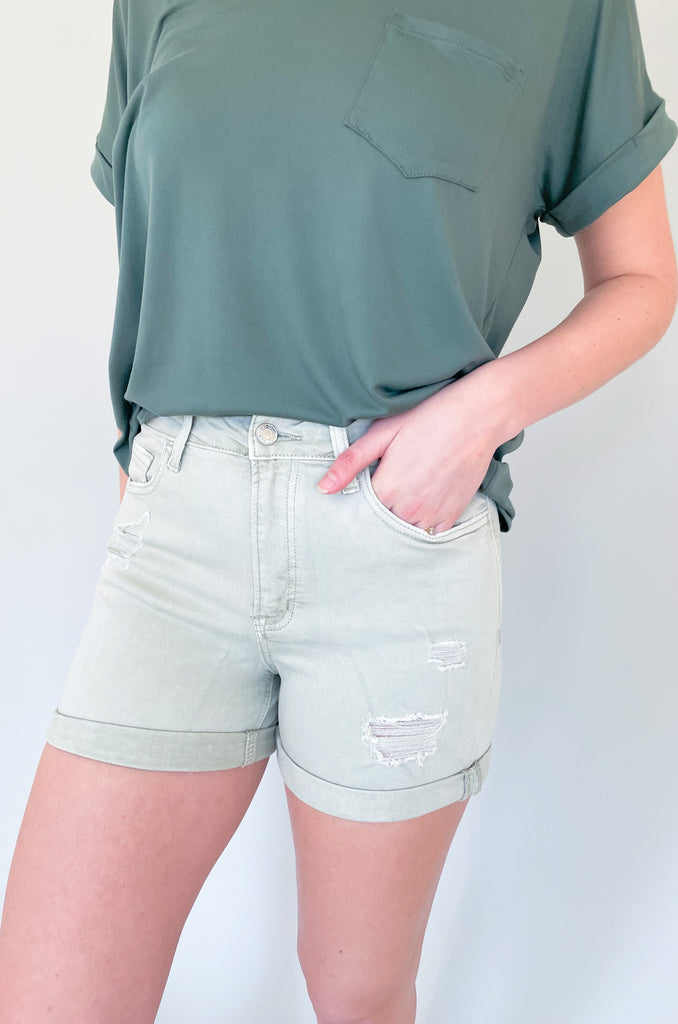 The Rebecca High Rise Distressed Shorts have a fresh look for spring and summer. Colored bottoms create an elevated outfit, plus they are just fun! This style is a washed, olive green with distressing on the front and back. The bottom hem can be unrolled to create a longer short. The fabric is soft and stretchy too! 