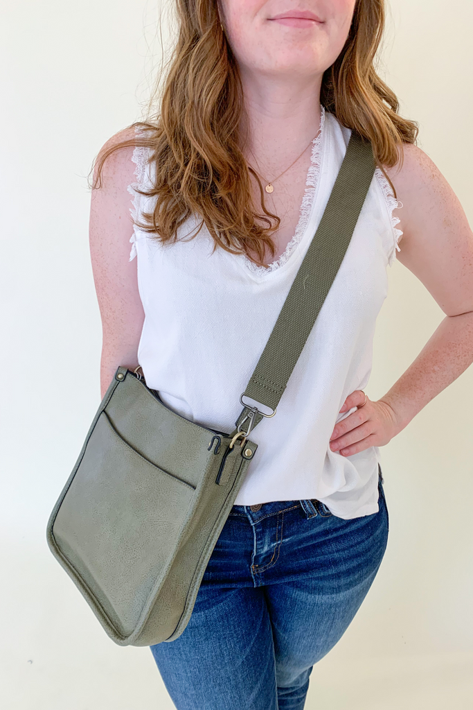 The Rosie Faux Leather Crossbody is a staple handbag! This faux leather bag has a soft a durable feel! There is a detachable, tonal, and adjustable strap that comes with the Rosie, or an Adjustable Fabric Guitar Strap is also available! Both options are so cute! This handbag is the smaller version of one of our best sellers, the Chloe Faux Leather Handbag with Guitar Strap. 
