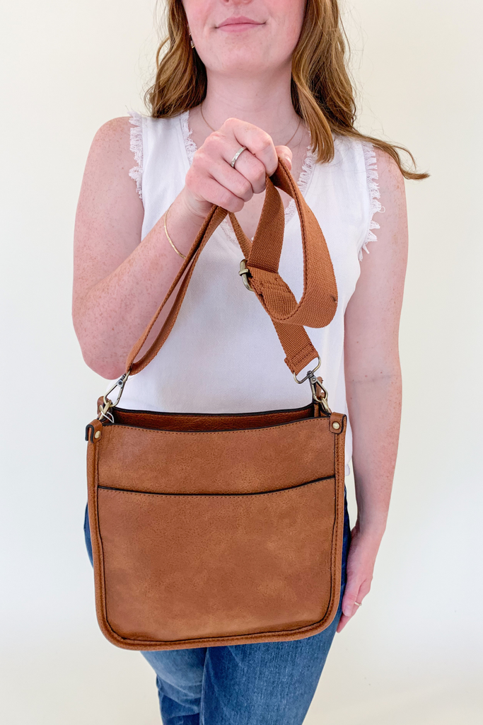 The Rosie Faux Leather Crossbody is a staple handbag! This faux leather bag has a soft a durable feel! There is a detachable, tonal, and adjustable strap that comes with the Rosie, or an Adjustable Fabric Guitar Strap is also available! Both options are so cute! This handbag is the smaller version of one of our best sellers, the Chloe Faux Leather Handbag with Guitar Strap. 
