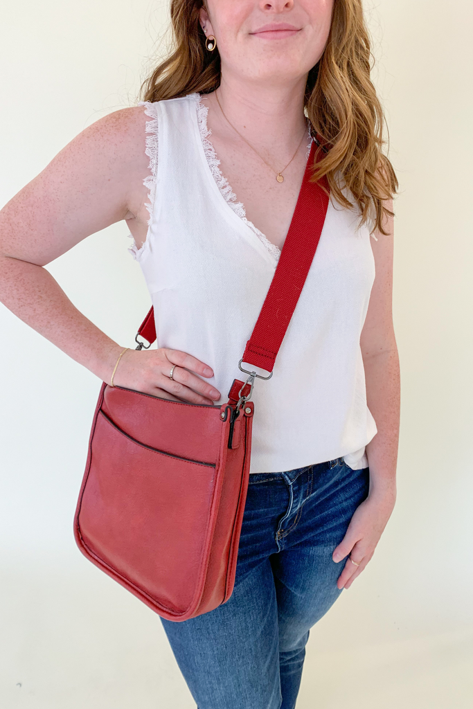 The Rosie Faux Leather Crossbody is a staple handbag! This faux leather bag has a soft a durable feel! There is a detachable, tonal, and adjustable strap that comes with the Rosie, or an Adjustable Fabric Guitar Strap is also available! Both options are so cute! This handbag is the smaller version of one of our best sellers, the Chloe Faux Leather Handbag with Guitar Strap. 
