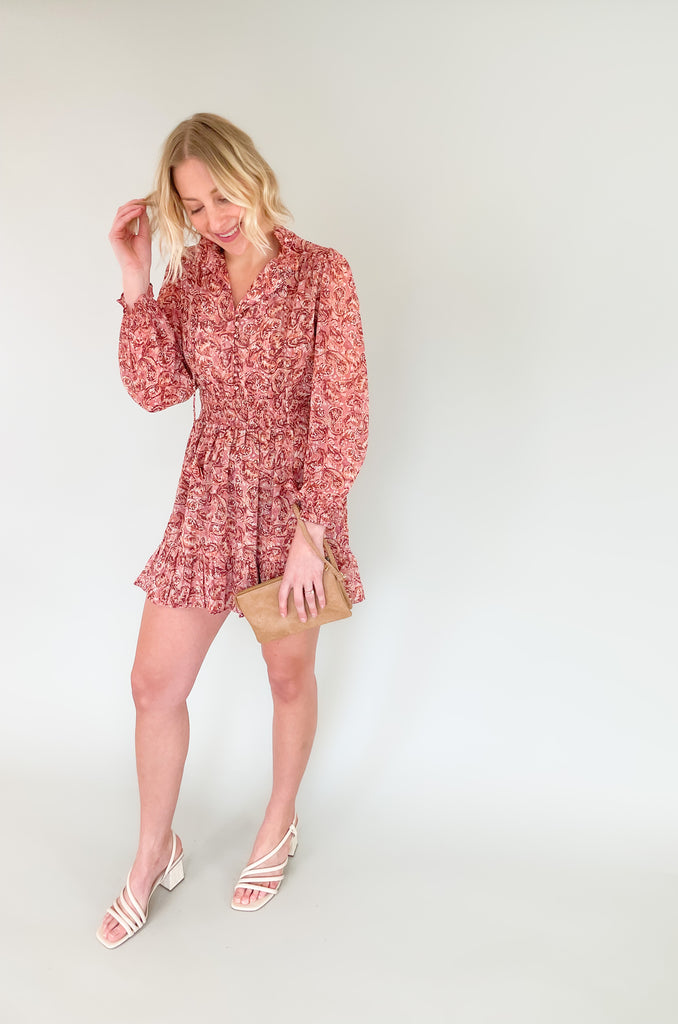 The Sangria Cinched Waist Long Sleeve Dress is so pretty and fun! We love the dusty pink floral print and feminine details- it has all! The top has a preppy collar with buttons and tassel ties. The waistband is elastic with a little flounce. Wear this dress to all of your spring and summer events for an effortless look! 