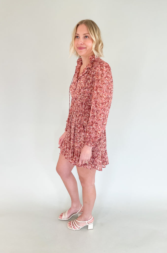 The Sangria Cinched Waist Long Sleeve Dress is so pretty and fun! We love the dusty pink floral print and feminine details- it has all! The top has a preppy collar with buttons and tassel ties. The waistband is elastic with a little flounce. Wear this dress to all of your spring and summer events for an effortless look! 