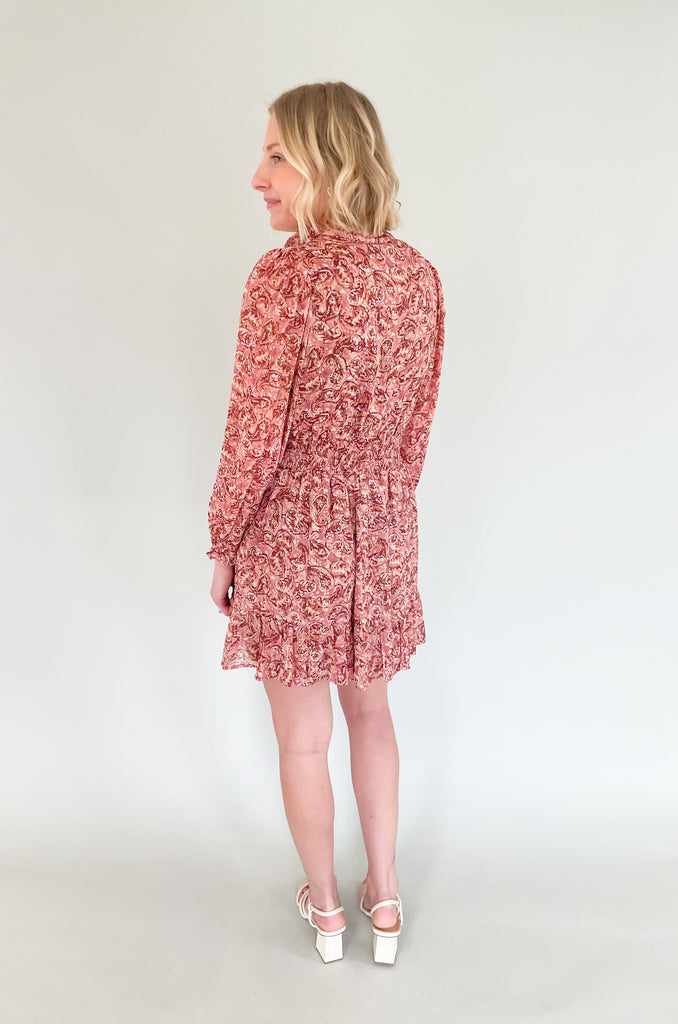 The Sangria Cinched Waist Long Sleeve Dress is so pretty and fun! We love the dusty pink floral print and feminine details- it has all! The top has a preppy collar with buttons and tassel ties. The waistband is elastic with a little flounce. Wear this dress to all of your spring and summer events for an effortless look! 
