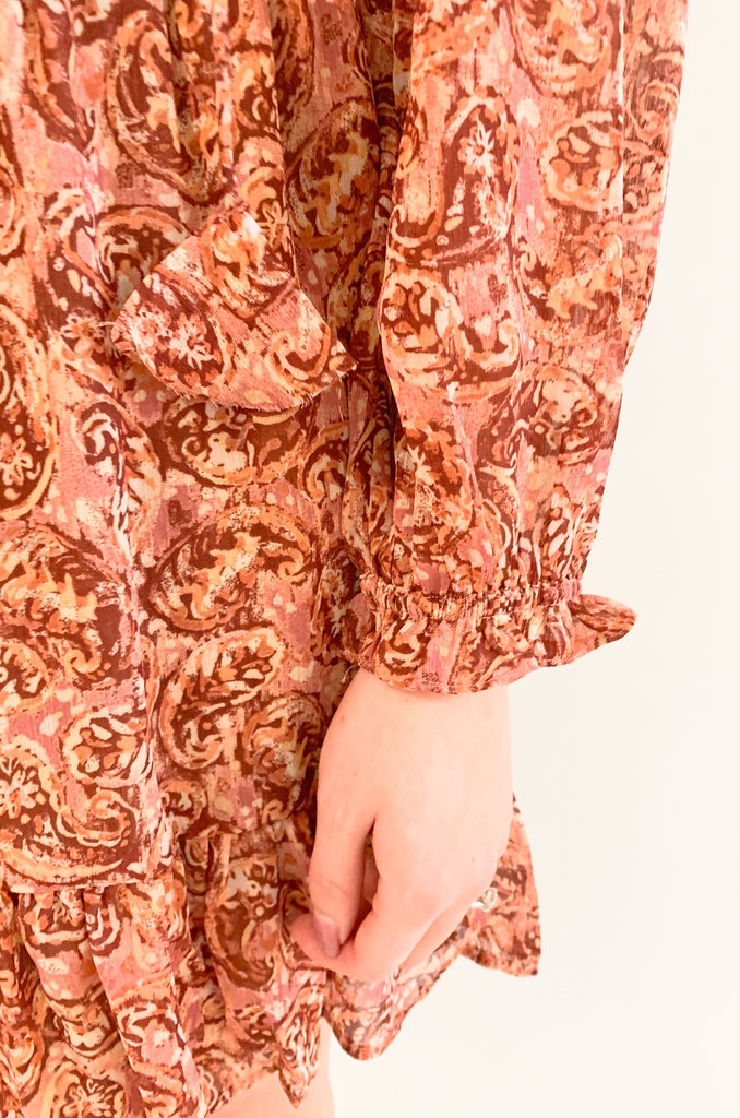 The Sangria Cinched Waist Long Sleeve Dress is so pretty and fun! We love the dusty pink floral print and feminine details- it has all! The top has a preppy collar with buttons and tassel ties. The waistband is elastic with a little flounce. Wear this dress to all of your spring and summer events for an effortless look! 