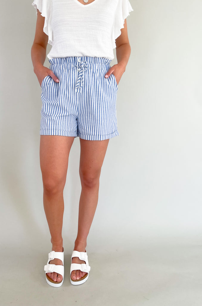 Out stylish and comfortable Navy and White Pin Stripe Shorts are the perfect addition to your summer wardrobe! Made from high-quality materials and feel so lightweight. Built for comfort, these shorts feature an elastic waist, adjustable tie, and side pockets.  These shorts are perfect for a day out with friends, a casual picnic or a relaxing day at the beach.