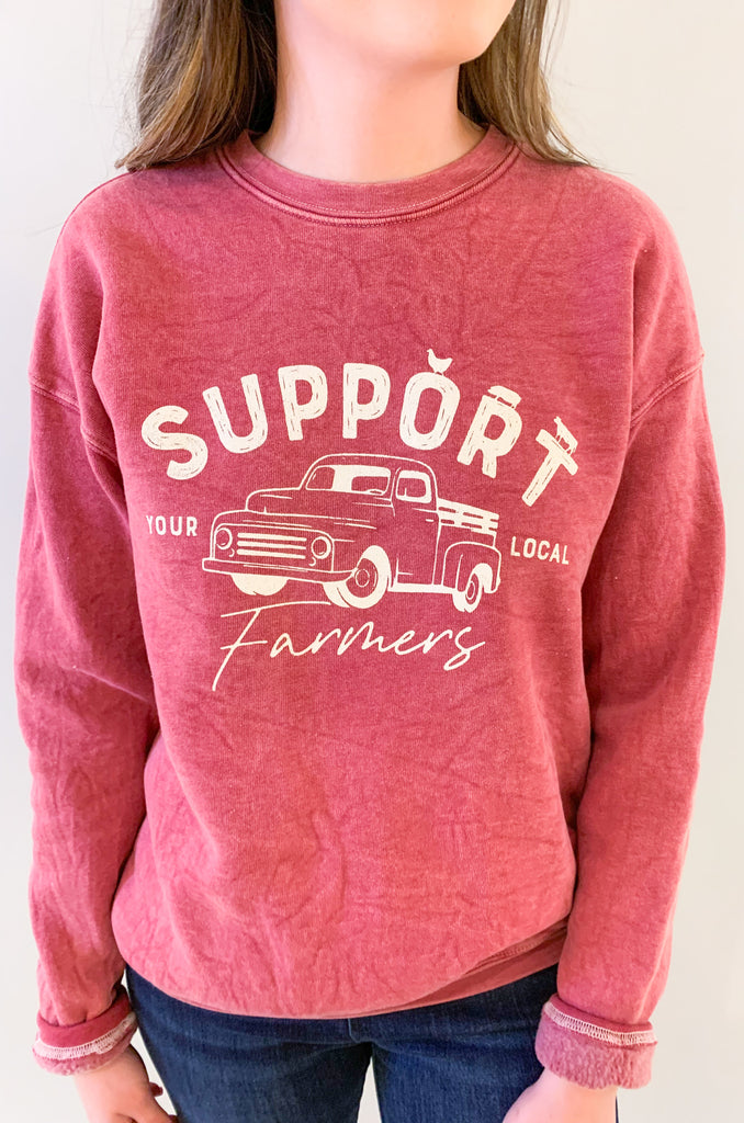 The Support Farmers Truck Mineral Washed Pullover is a cute and casual style, perfect for everyday wear. It has a unique graphic print and a fun, mineral-wash look. Because of the dying process, each pullover is slightly different in color variation. On the inside, this style is lined with the coziest fleece. You will be reaching for it again and again!