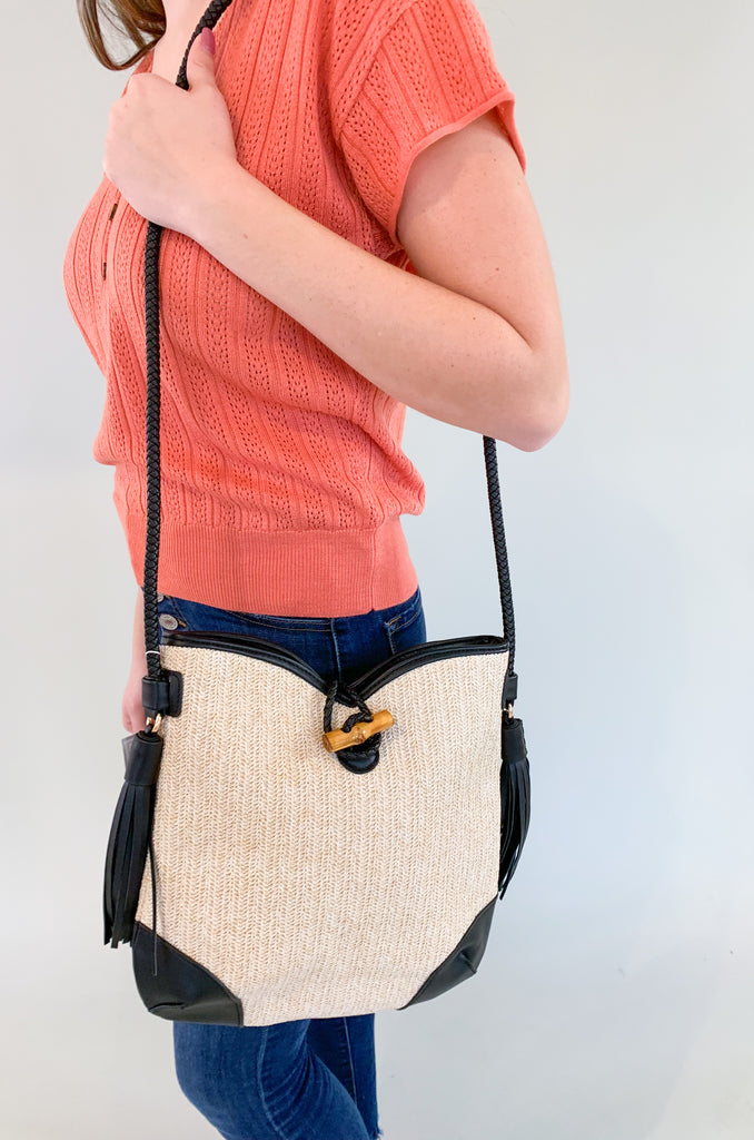The Vonnie Straw Crossbody with Toggle Fastening is the perfect summer bag! The straw detail is so fun- and a hot trend we are seeing in handbags right now. Add the black and it becomes a very wearable look. You can pair this purse with so many outfits for an elevated style. 