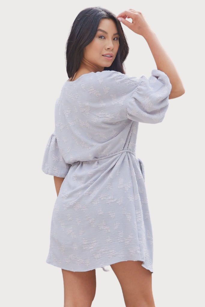 Feminine, flirty, and fun- this stunning dress checks all of the boxes! If you have a special event, date night, or celebration to attend, the Tarah Textured Fabric Dress is a great option! It is stretchy with a very comfortable, lightweight feel. You can wear it looser, or tie the waist for a cinched look. It has elegant balloon sleeves and a unique texture.