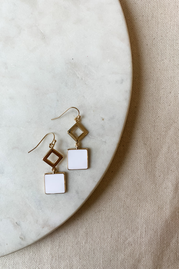 The White Enamel Geometric Dangle Earrings are so fun! We love the unique geo design paired with the gold and white coloring. They look very modern and elevated. Plus, they are comfortable for all day wear! 