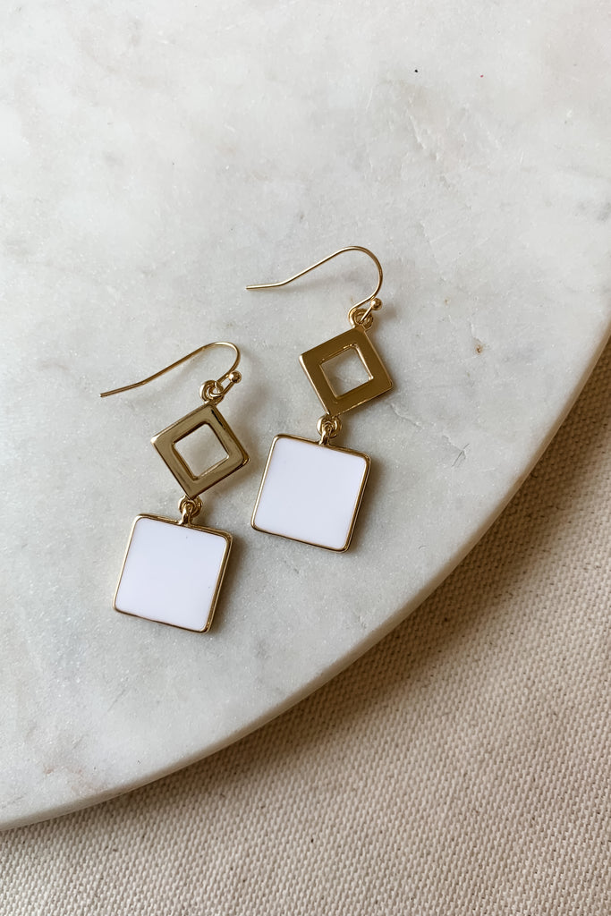 The White Enamel Geometric Dangle Earrings are so fun! We love the unique geo design paired with the gold and white coloring. They look very modern and elevated. Plus, they are comfortable for all day wear! 